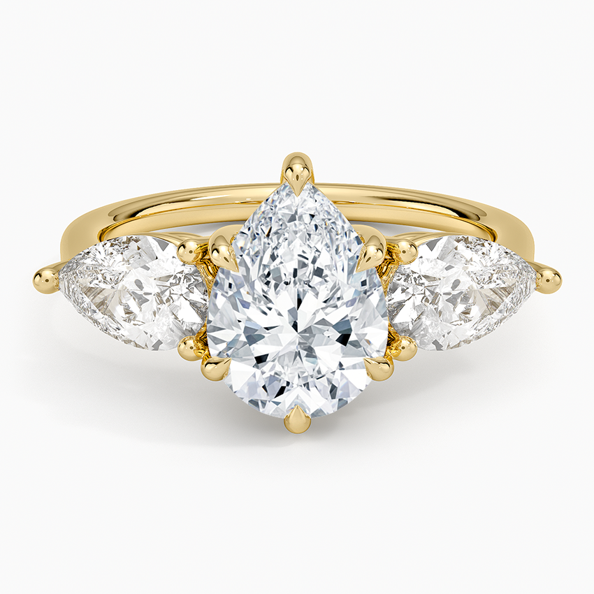 Pear cut moissanite with two east west pear side stones in yellow gold, top view