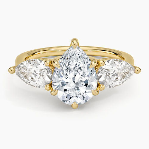 Pear cut moissanite with two east west pear side stones in yellow gold, top view