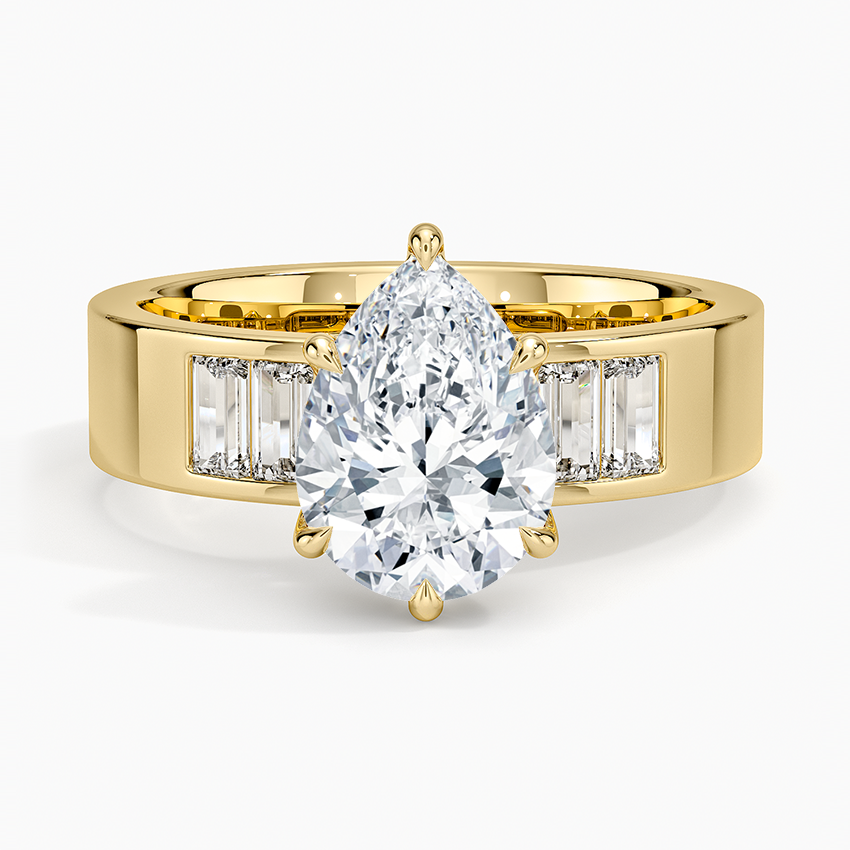 Pear cut moissanite ring on a wide flat band with channel set baguettes, top view