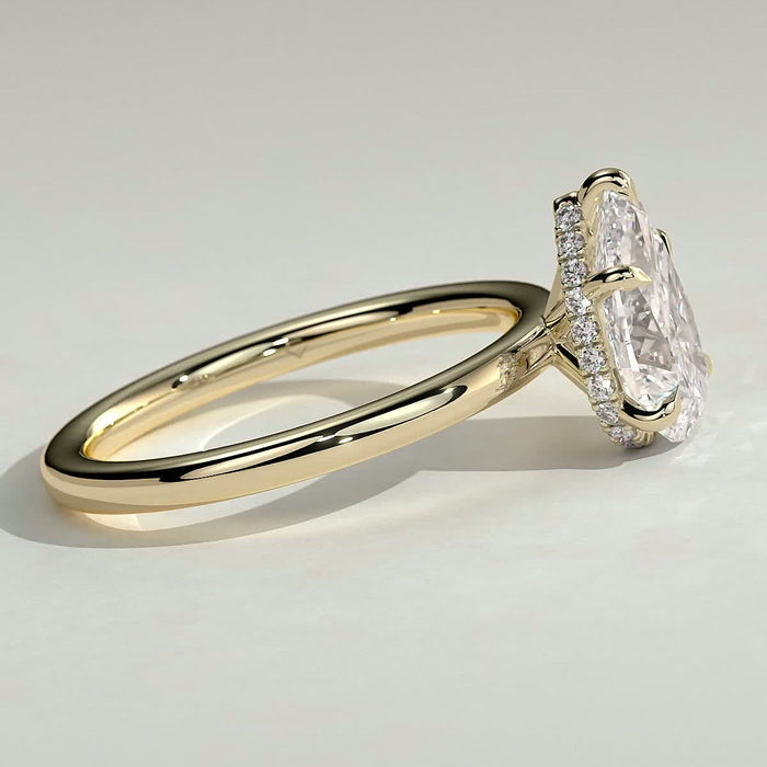 Pear cut moissanite five claw solitaire engagement ring on a plain yellow gold band, view 2