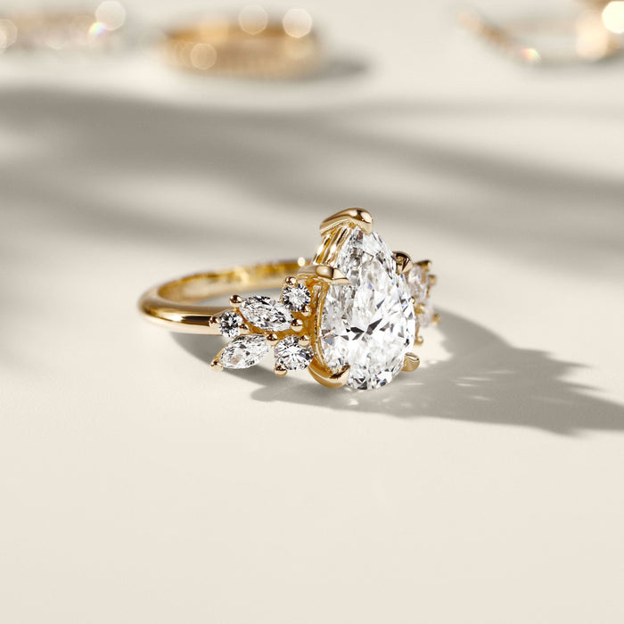 Pear cut moissanite full wing cluster engagement ring in yellow gold, view 2