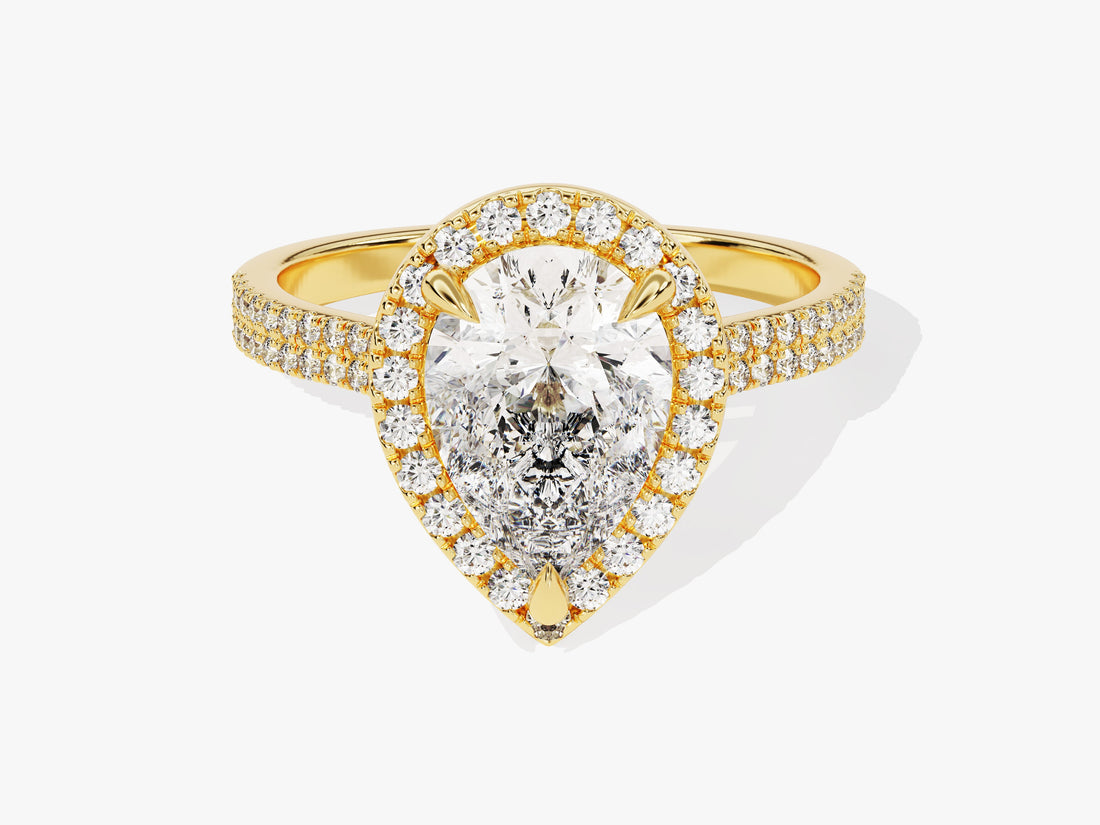 Pear cut moissanite halo engagement ring with double row pave band in yellow gold, front view