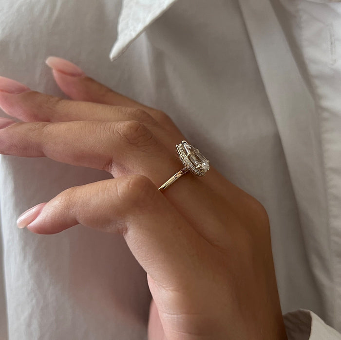 Pear cut moissanite hidden halo engagement ring in rose gold, view 2