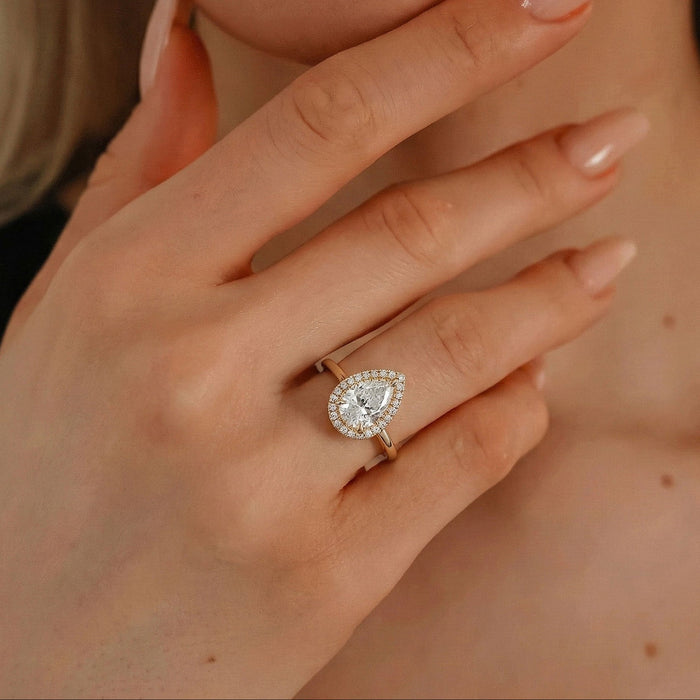 Pear cut moissanite halo engagement ring in yellow gold, view 2