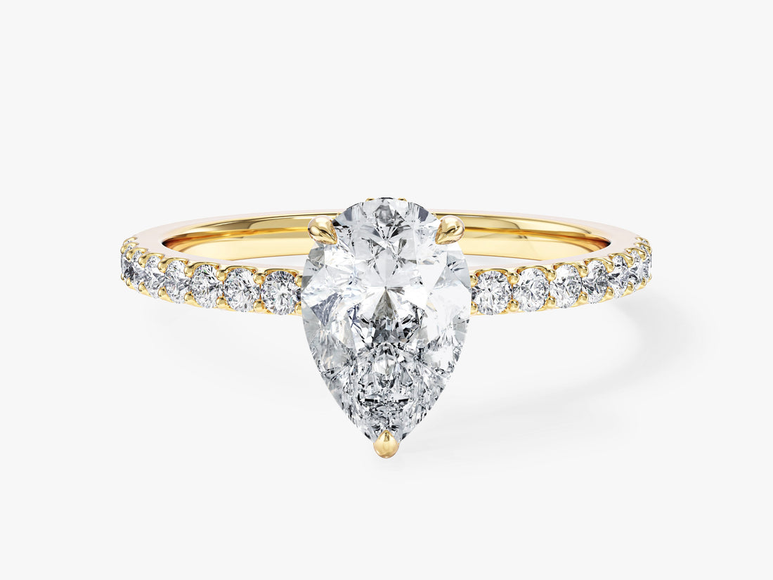 Pear cut moissanite pave band engagement ring with hidden halo in 14K yellow gold, front view