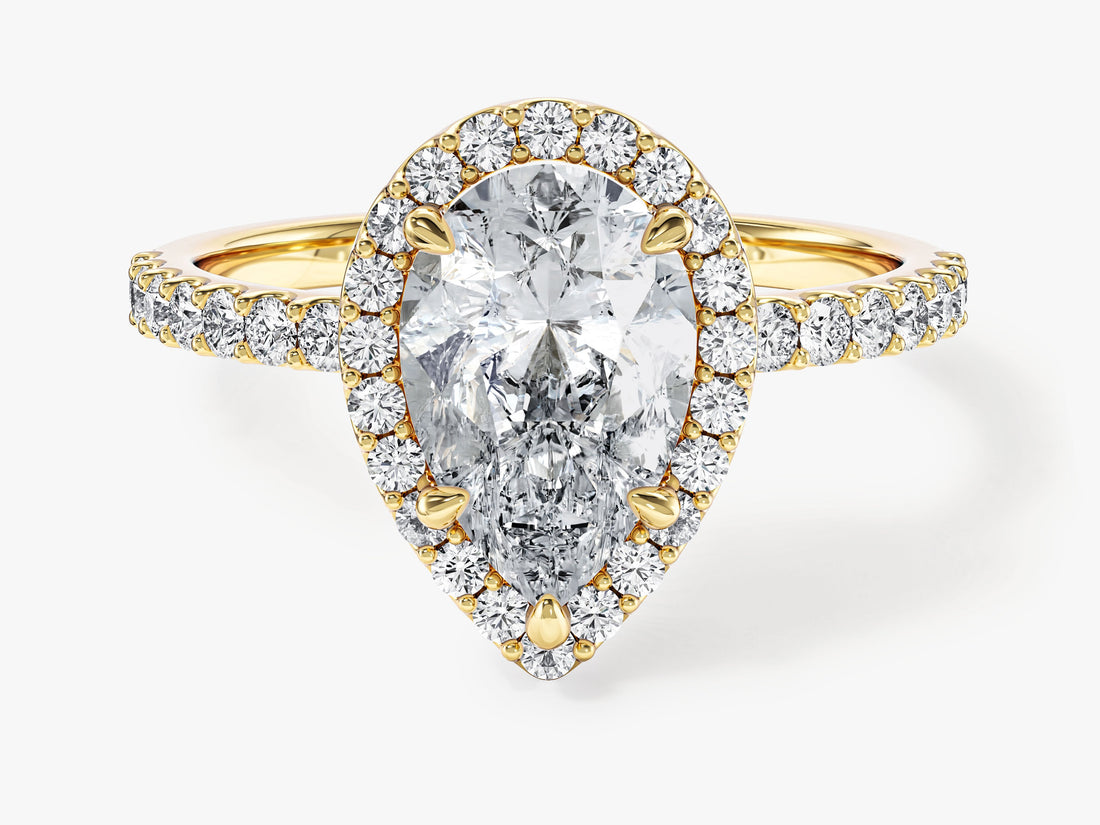 Pear cut moissanite halo engagement ring with pave band in 14K yellow gold, front view