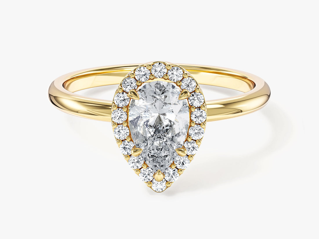 Dainty pear halo moissanite engagement ring with thin plain shank in yellow gold, front view