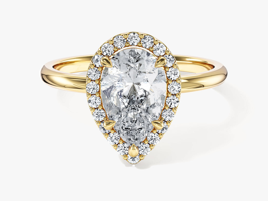 Pear shaped moissanite halo engagement ring with slim plain band in yellow gold, front view