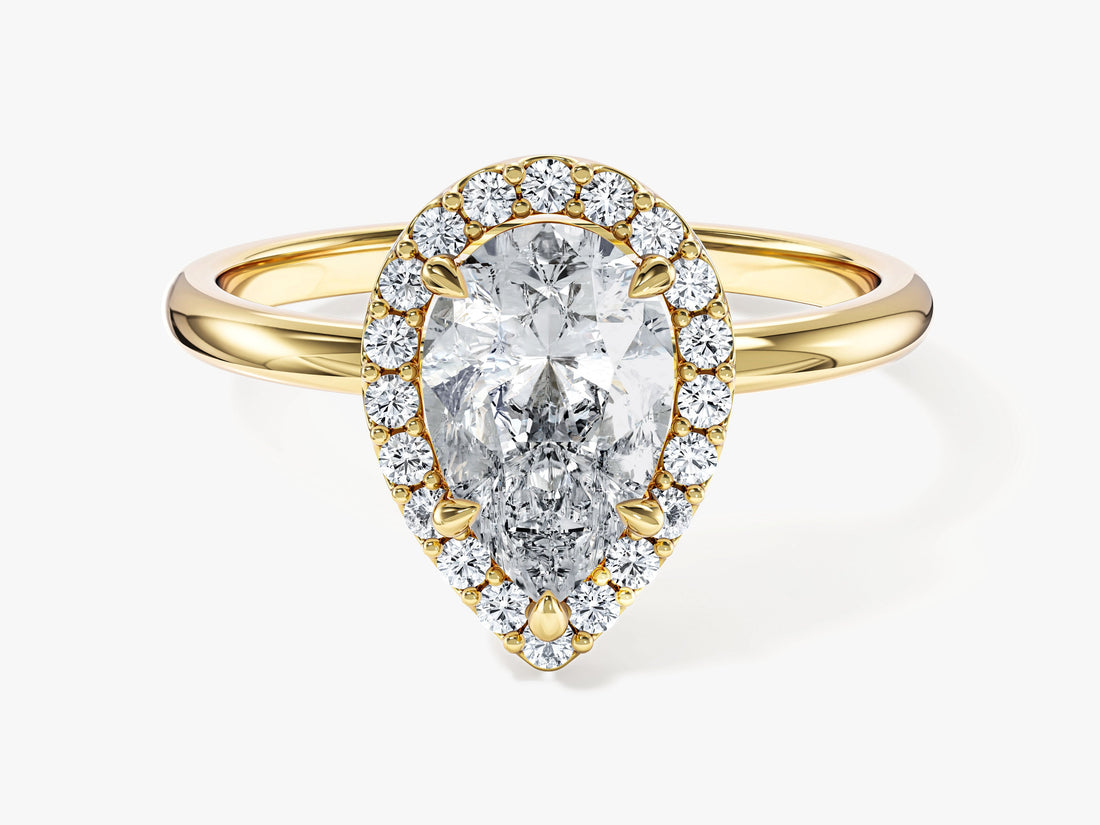 Teardrop pear moissanite halo engagement ring on a polished yellow gold band, front view