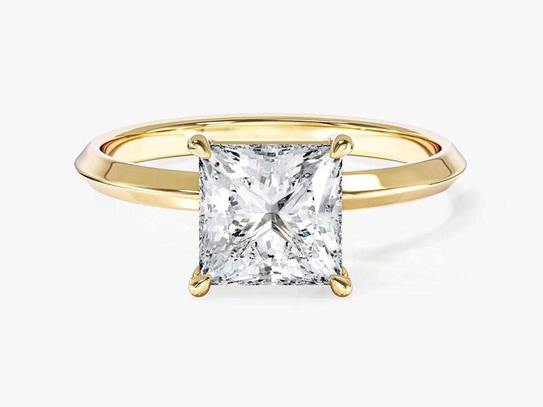 Four claw princess cut lab grown diamond engagement ring with knife edge band in yellow gold, front view