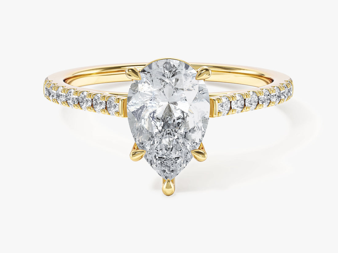 Teardrop pear moissanite engagement ring with micro pave shoulders in yellow gold, front view
