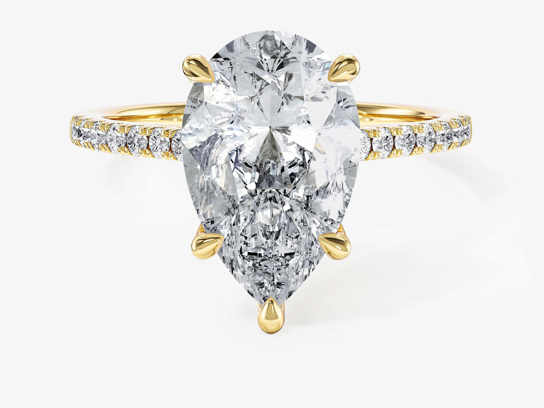 Pear cut moissanite pave engagement ring with five claw setting in yellow gold, front view