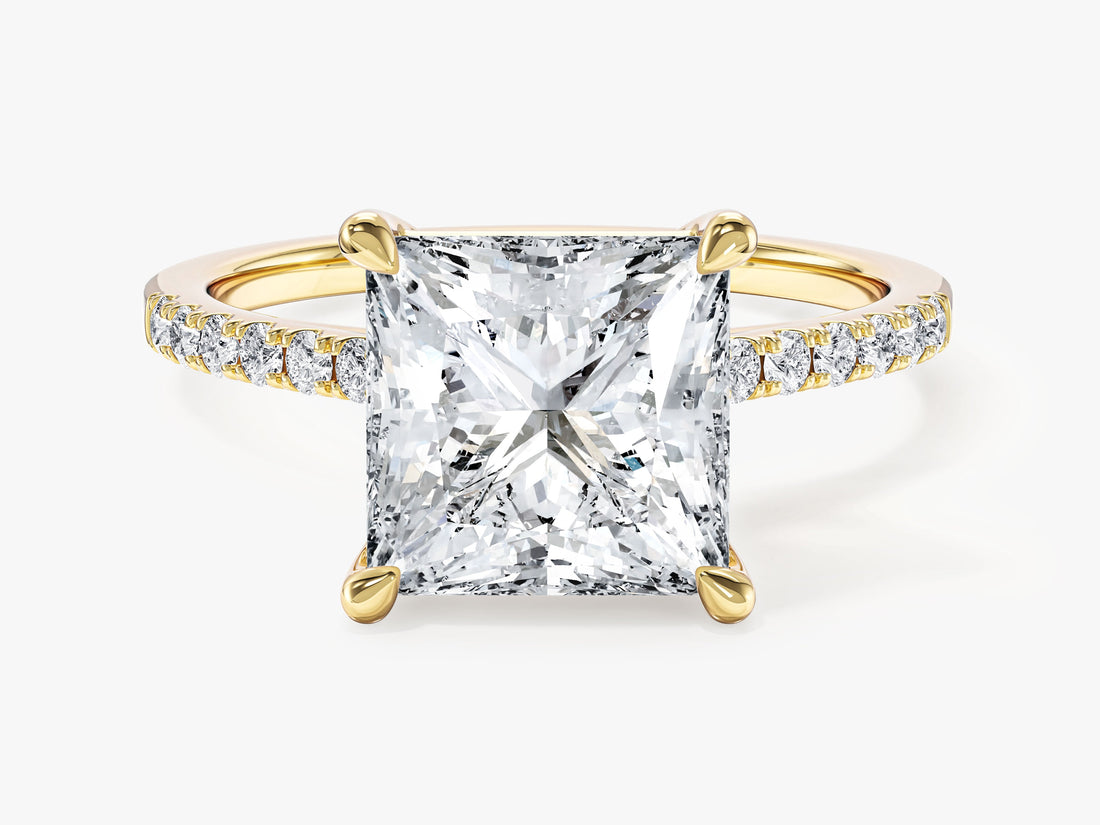 Large princess cut moissanite statement engagement ring on a pave band in 14K yellow gold, front view
