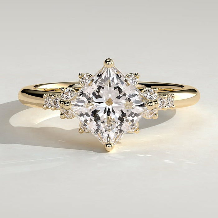 Princess cut moissanite on point engagement ring with corner clusters in yellow gold