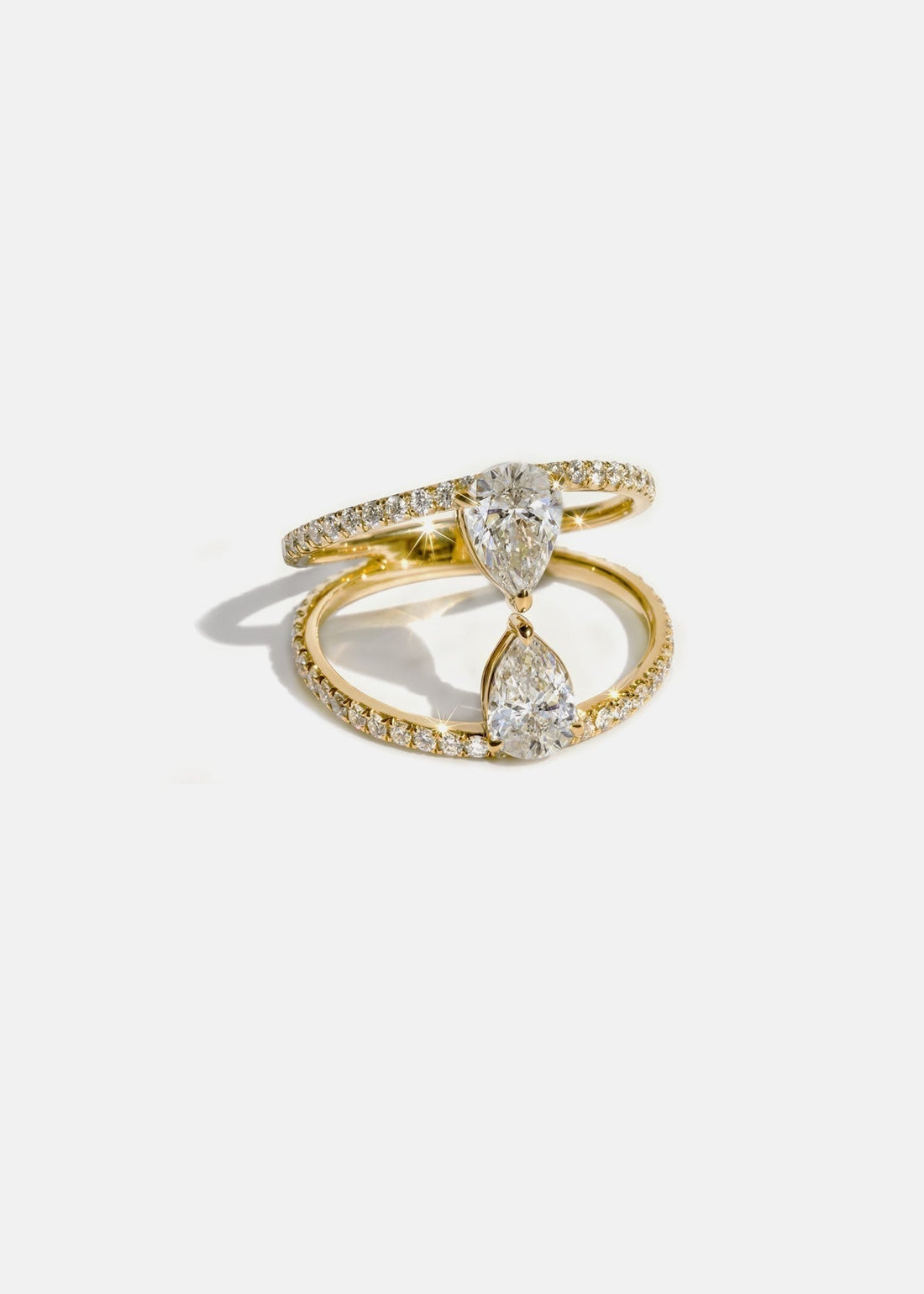 Two pear cut moissanite engagement ring on a pave double band in yellow gold