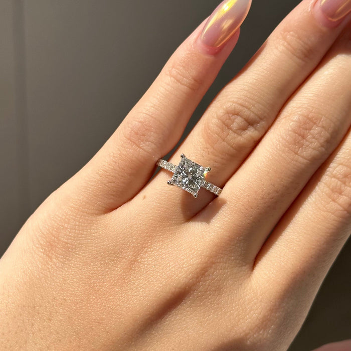 Princess cut moissanite engagement ring on a pave set white gold band, view 2