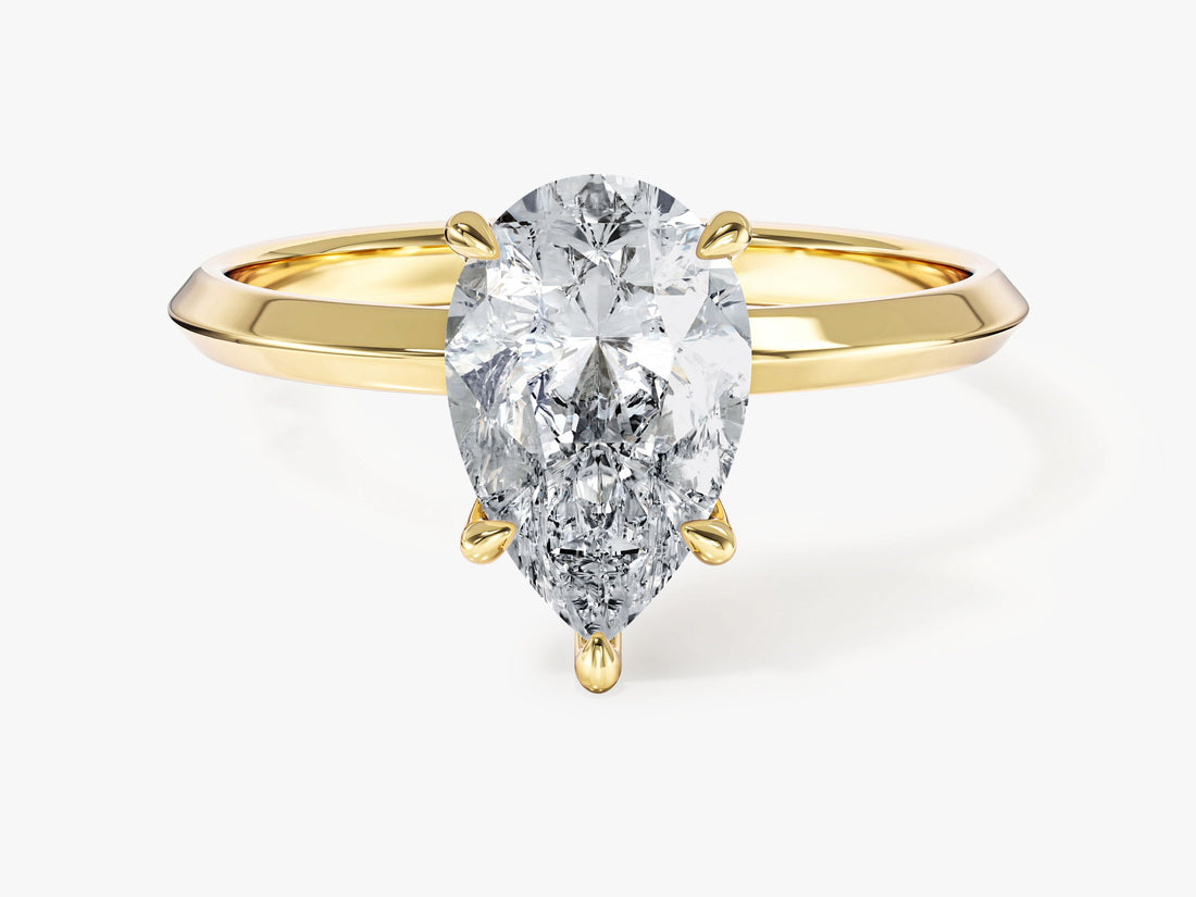 Pear cut moissanite five prong solitaire with knife edge band in 14K yellow gold, front view