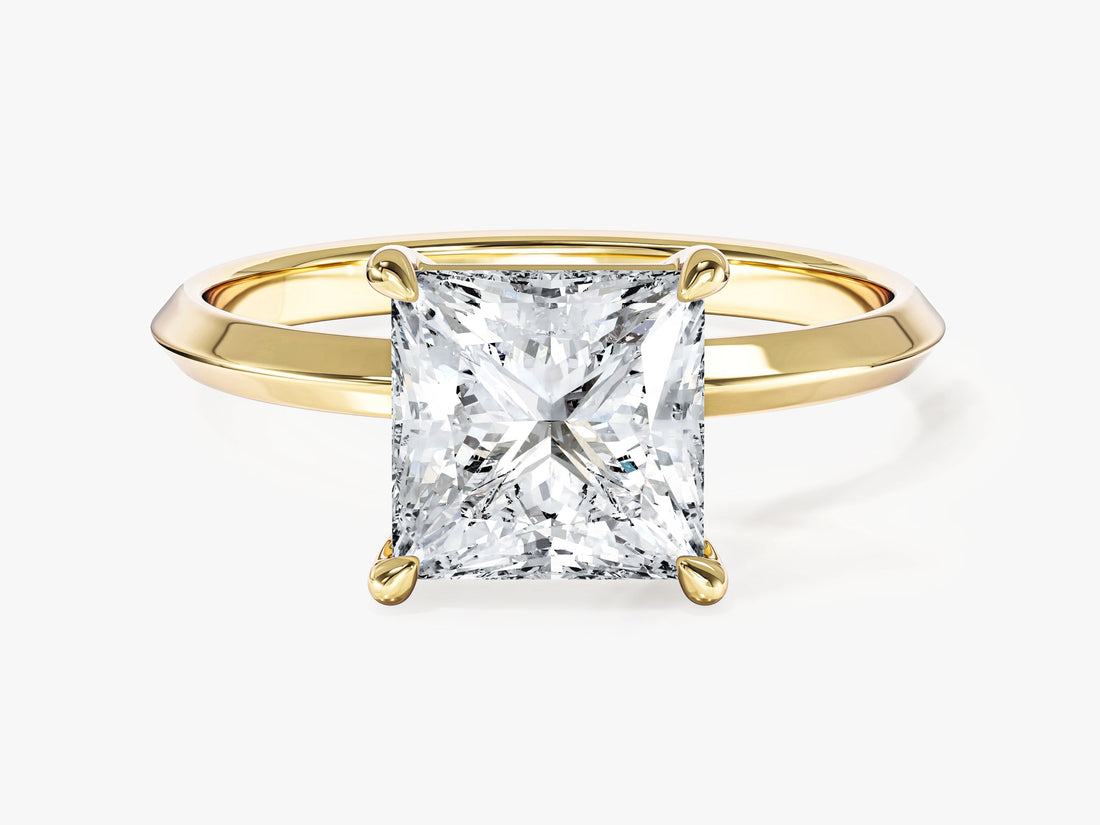 Princess cut moissanite knife edge solitaire engagement ring in yellow gold, front view