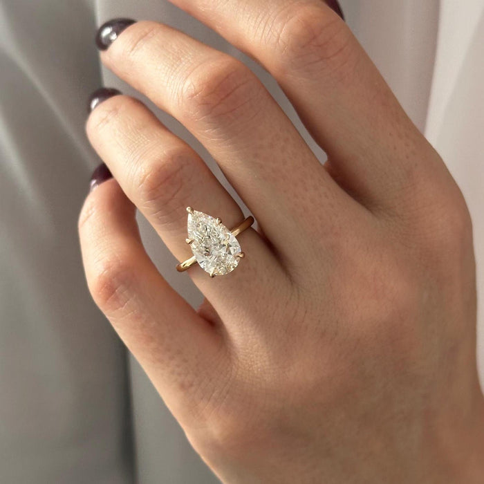 Pear cut moissanite solitaire engagement ring in yellow gold, view 2