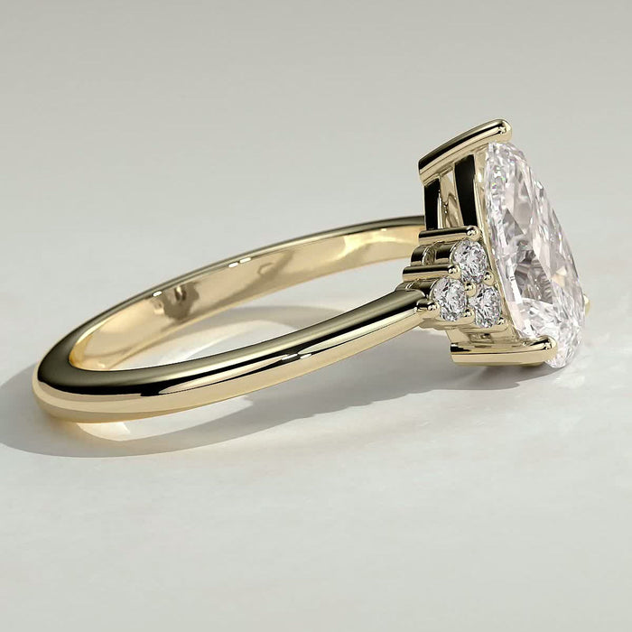 Pear cut moissanite engagement ring with triangular cluster shoulders in yellow gold, view 2