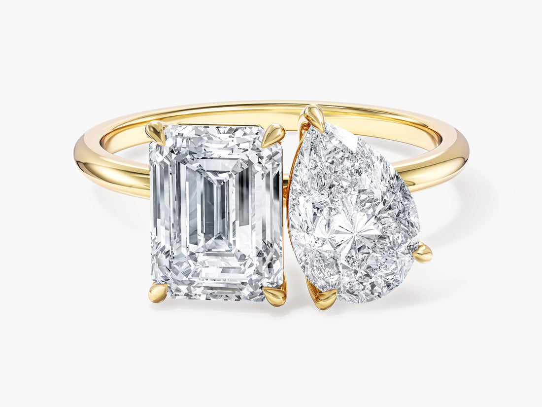 Pear and emerald cut moissanite toi et moi engagement ring in yellow gold, front view
