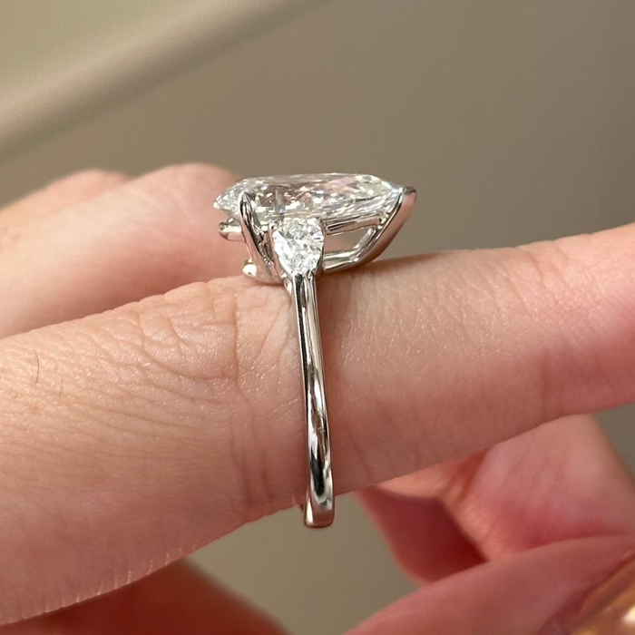 Pear cut moissanite three stone engagement ring with pear side stones in white gold, view 2