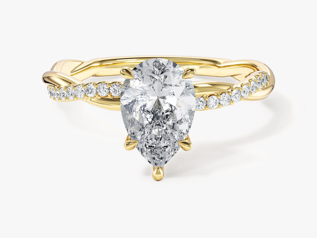 Pear cut moissanite twist engagement ring with pave side stones in 14K yellow gold, front view
