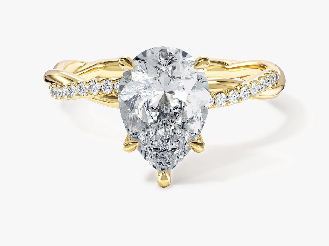 Pear moissanite infinity twist engagement ring with half pave band in 14K yellow gold, front view