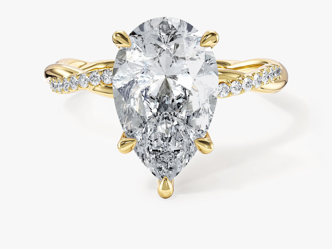 Large pear moissanite statement engagement ring with twisted pave band in 14K yellow gold, front view