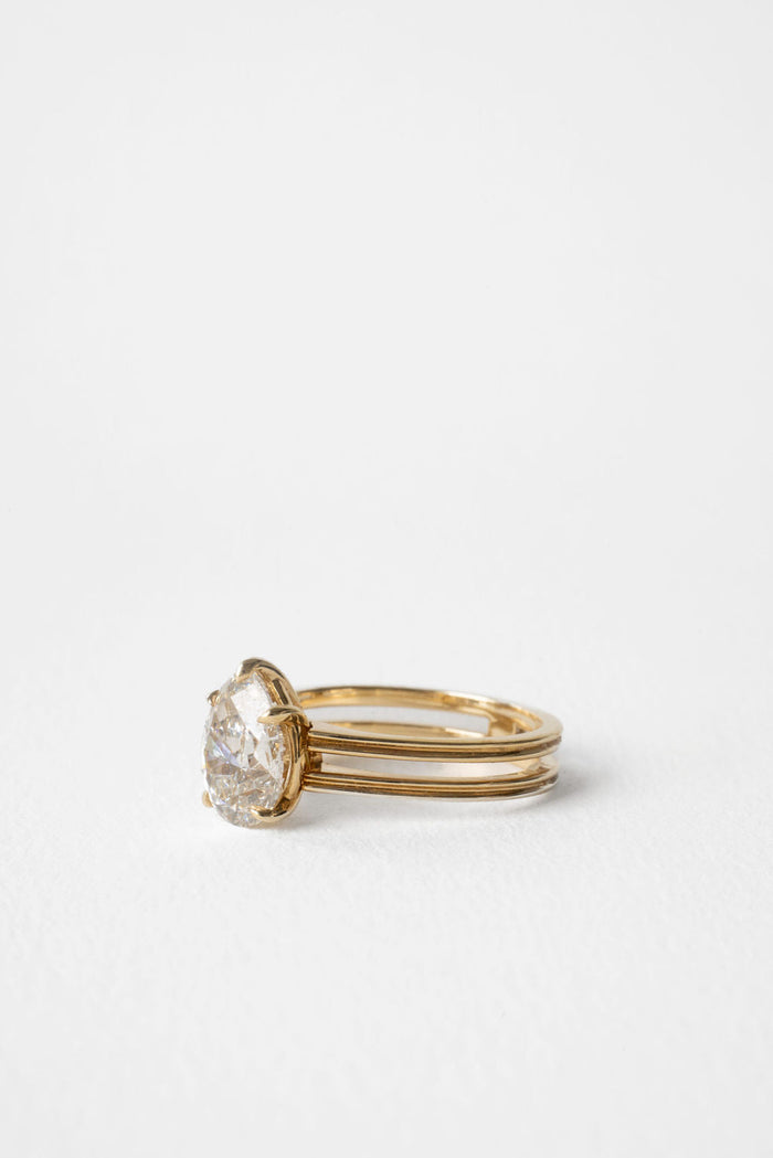Pear cut moissanite triple rail shank solitaire engagement ring in yellow gold, view 2