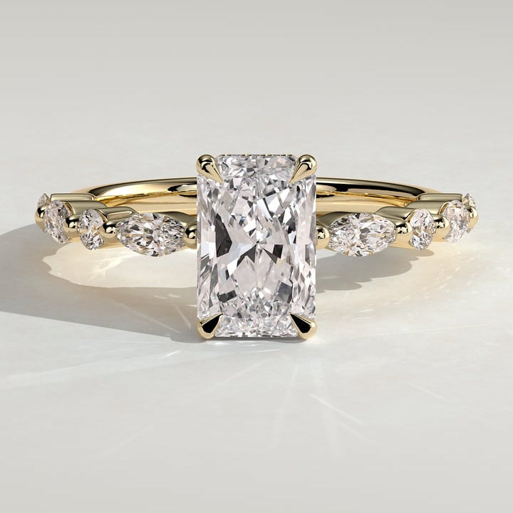 Radiant cut moissanite engagement ring with alternating marquise and round accents in yellow gold