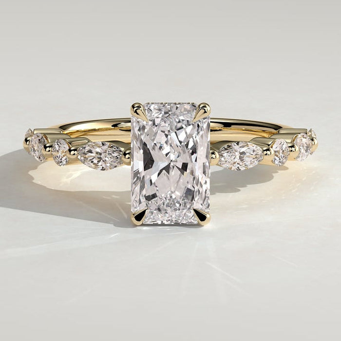 Radiant cut moissanite engagement ring with alternating marquise and round accents in yellow gold