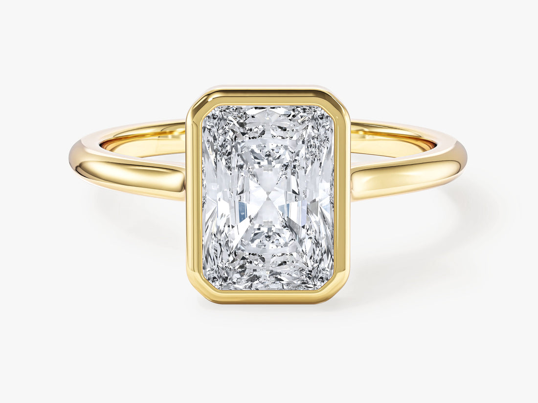 Radiant cut moissanite bezel set solitaire engagement ring with plain band in yellow gold, front view