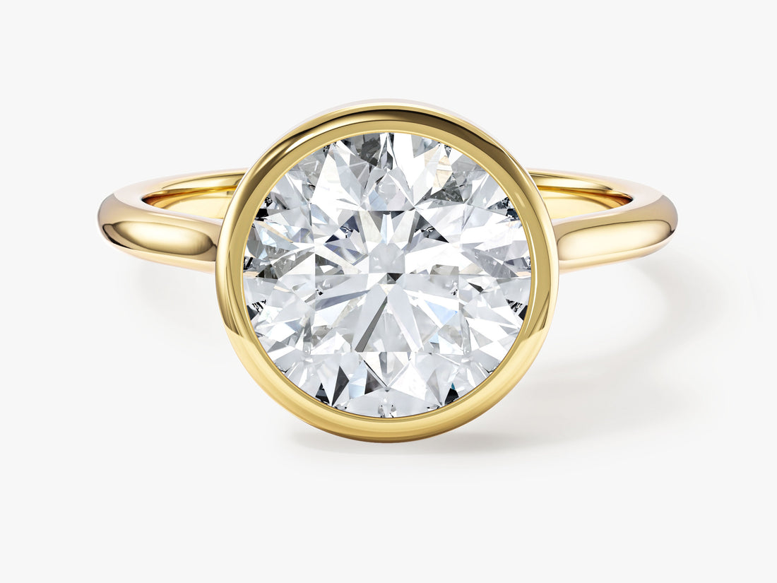 Large round moissanite bezel set solitaire engagement ring in yellow gold, front view