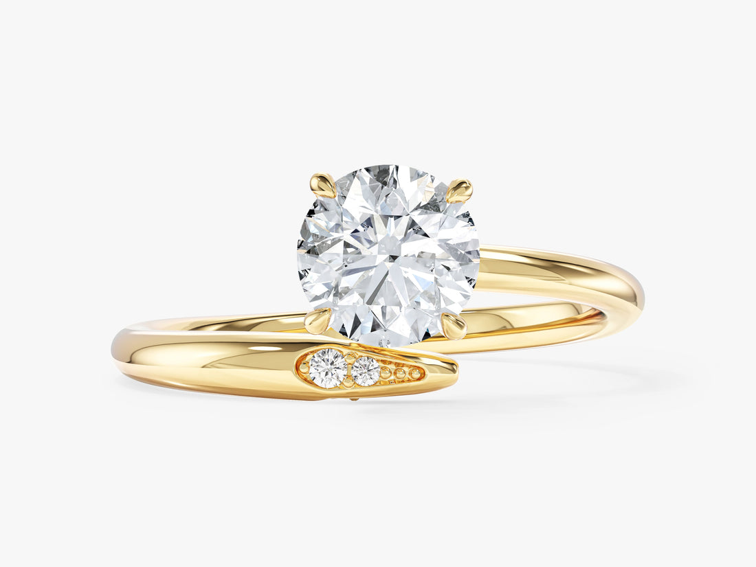 Round cut moissanite bypass engagement ring with open shank and accent stones in 14K yellow gold, front view