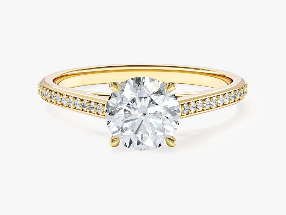 Round lab grown diamond four prong engagement ring with tapered pave cathedral band in yellow gold, front view