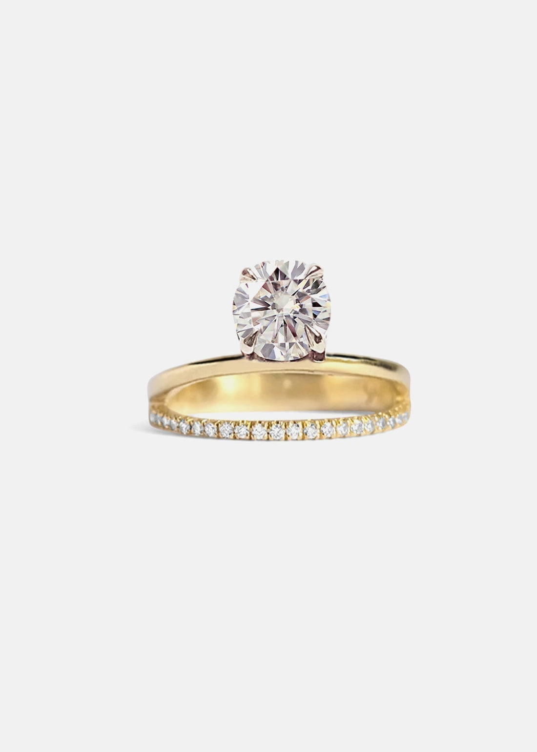 Round brilliant moissanite engagement ring on a plain and pave double band in yellow gold
