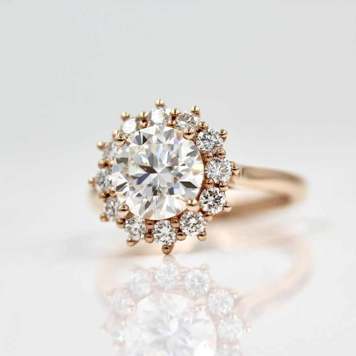 Round brilliant moissanite double row cluster starburst halo engagement ring in rose gold, view 2