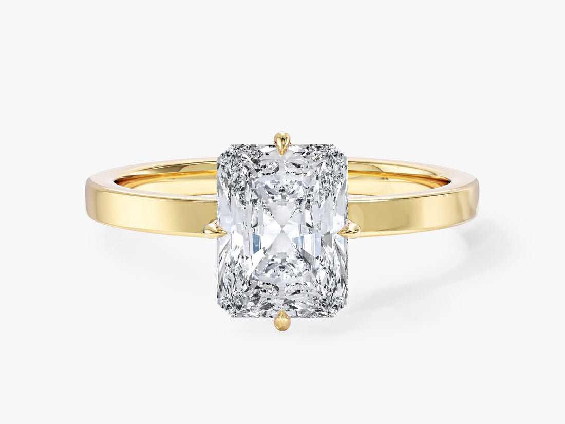 Radiant cut moissanite solitaire engagement ring with compass prongs and flat band in 14K yellow gold, front view
