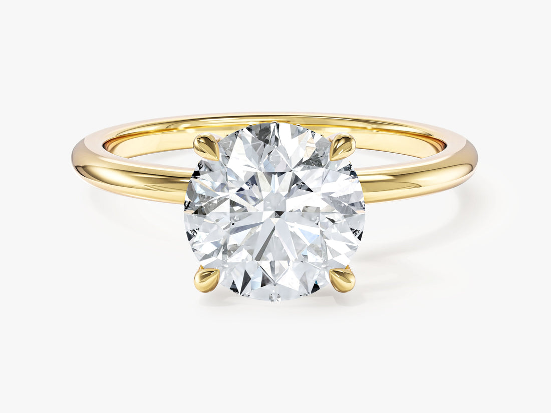 Four prong round lab grown diamond engagement ring with hidden halo in yellow gold, front view
