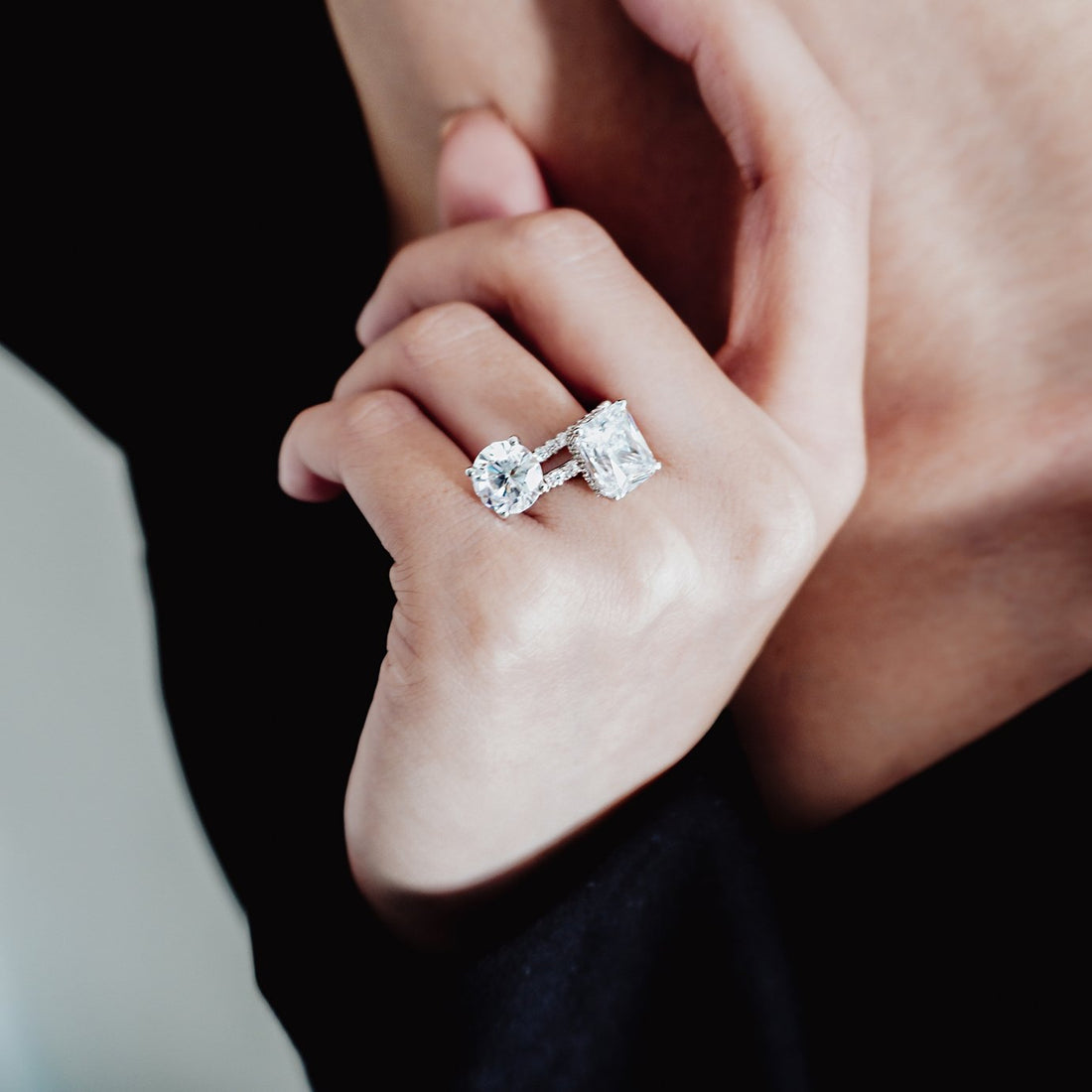 Round brilliant moissanite four claw engagement ring on a French pave shank in white gold