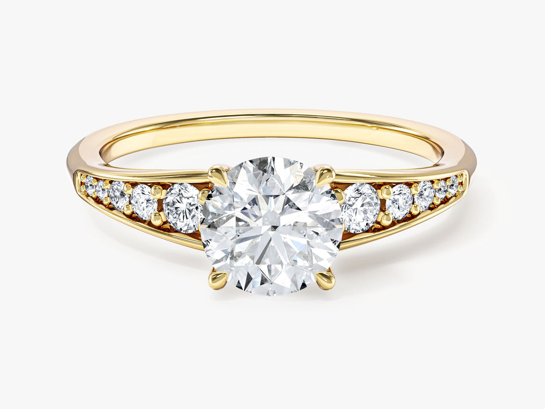 Round moissanite pave crown engagement ring with graduated tapered shoulders in yellow gold, front view