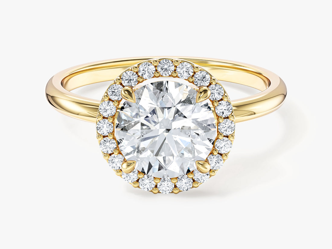 Round cut moissanite micro prong halo engagement ring with polished band in yellow gold, front view