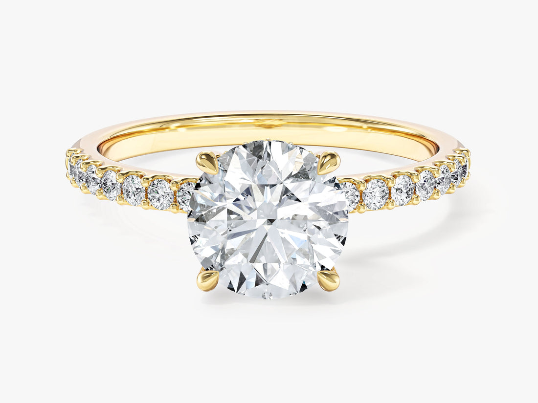 Round brilliant moissanite hidden halo engagement ring with pave band in yellow gold, front view