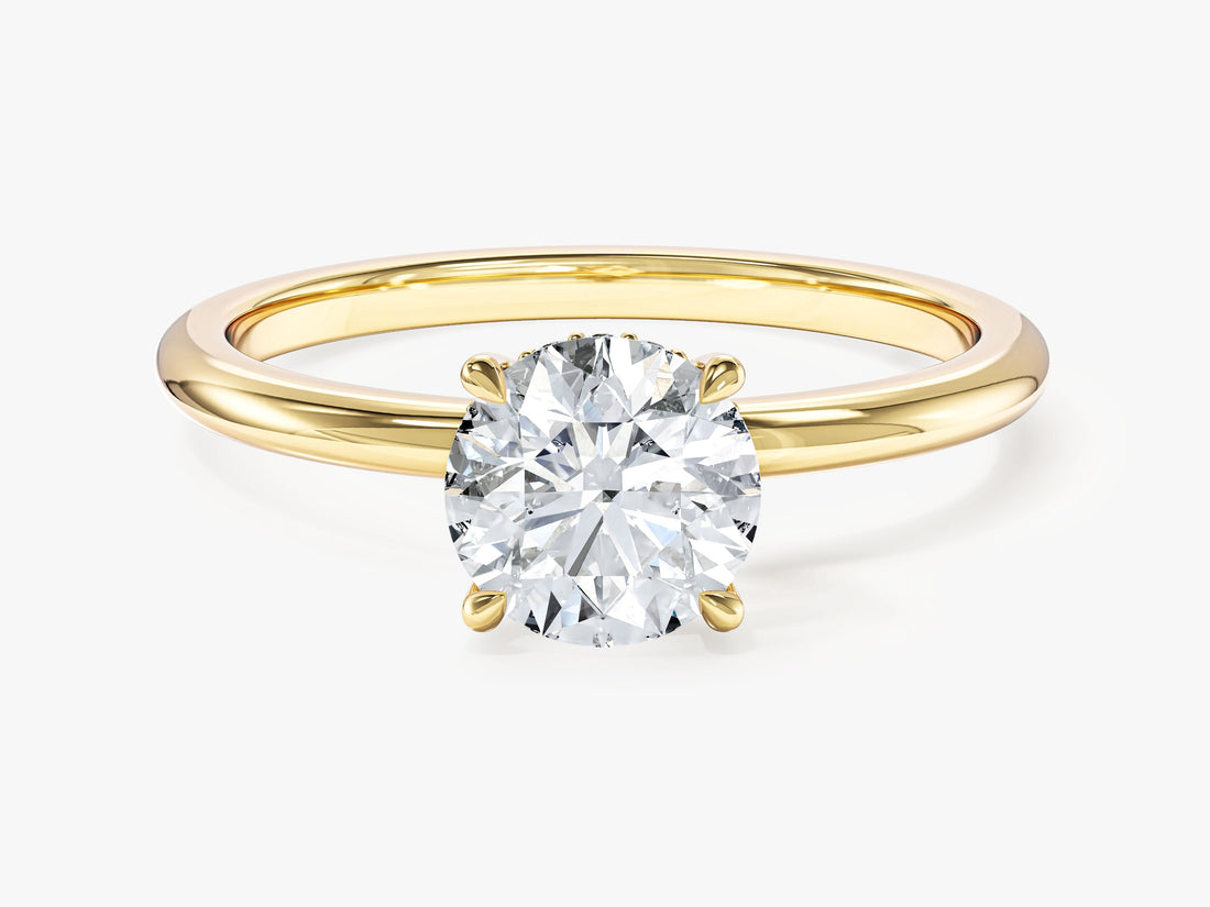 Dainty round moissanite hidden halo engagement ring with four prongs in yellow gold, front view