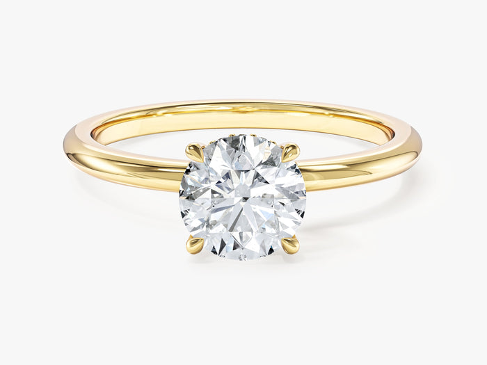 Dainty round moissanite hidden halo engagement ring with four prongs in yellow gold, front view