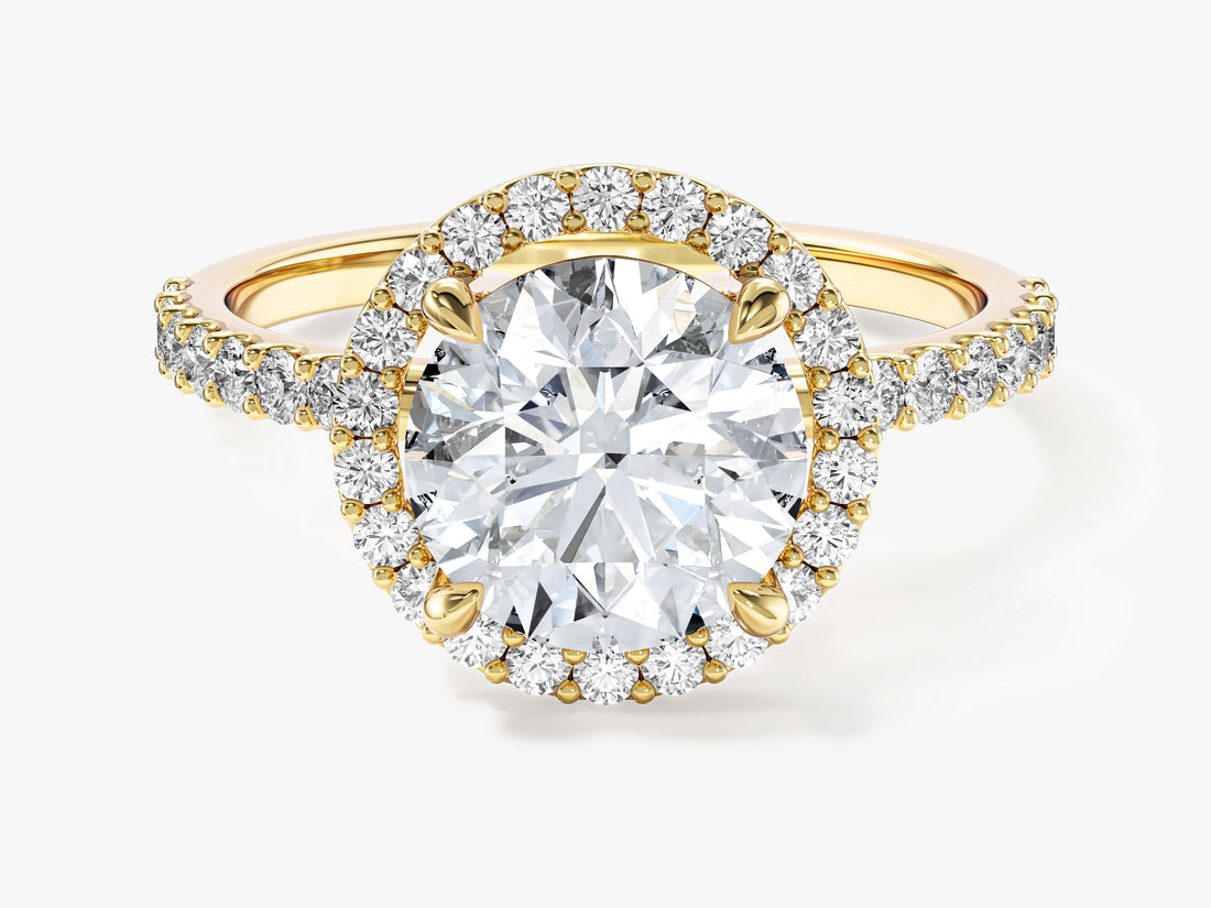 Sparkly round moissanite halo engagement ring with pave band in yellow gold, front view