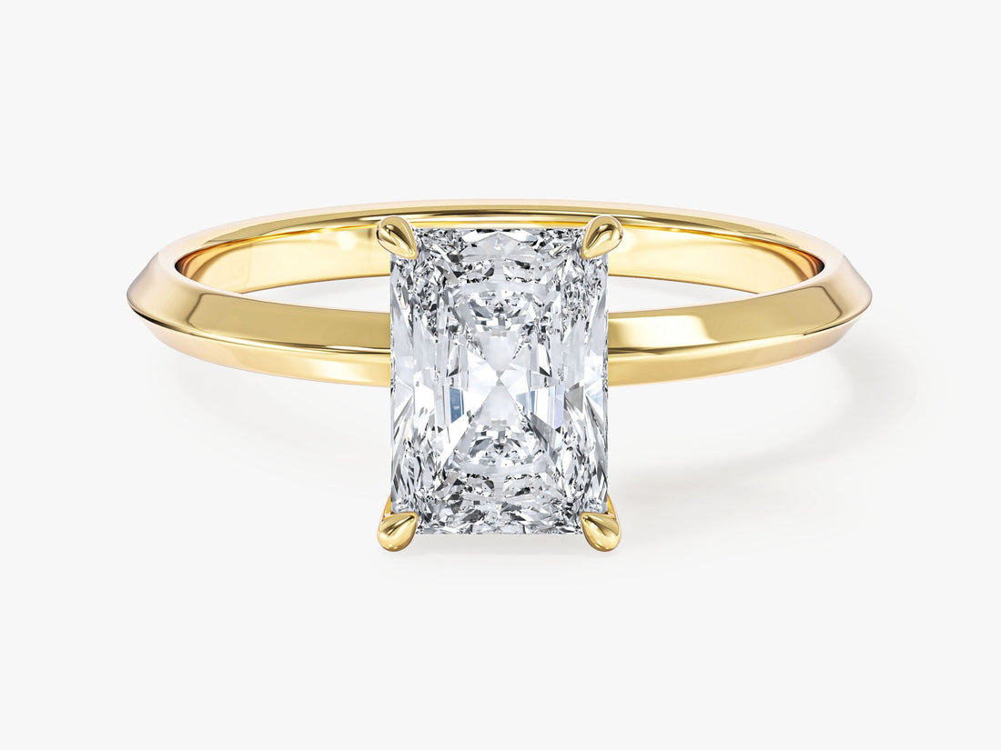 Rectangle radiant moissanite four prong engagement ring on a knife edge band in 14K yellow gold