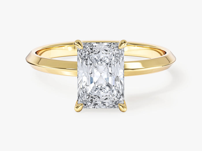 Elongated radiant lab grown diamond four prong engagement ring in yellow gold, front view