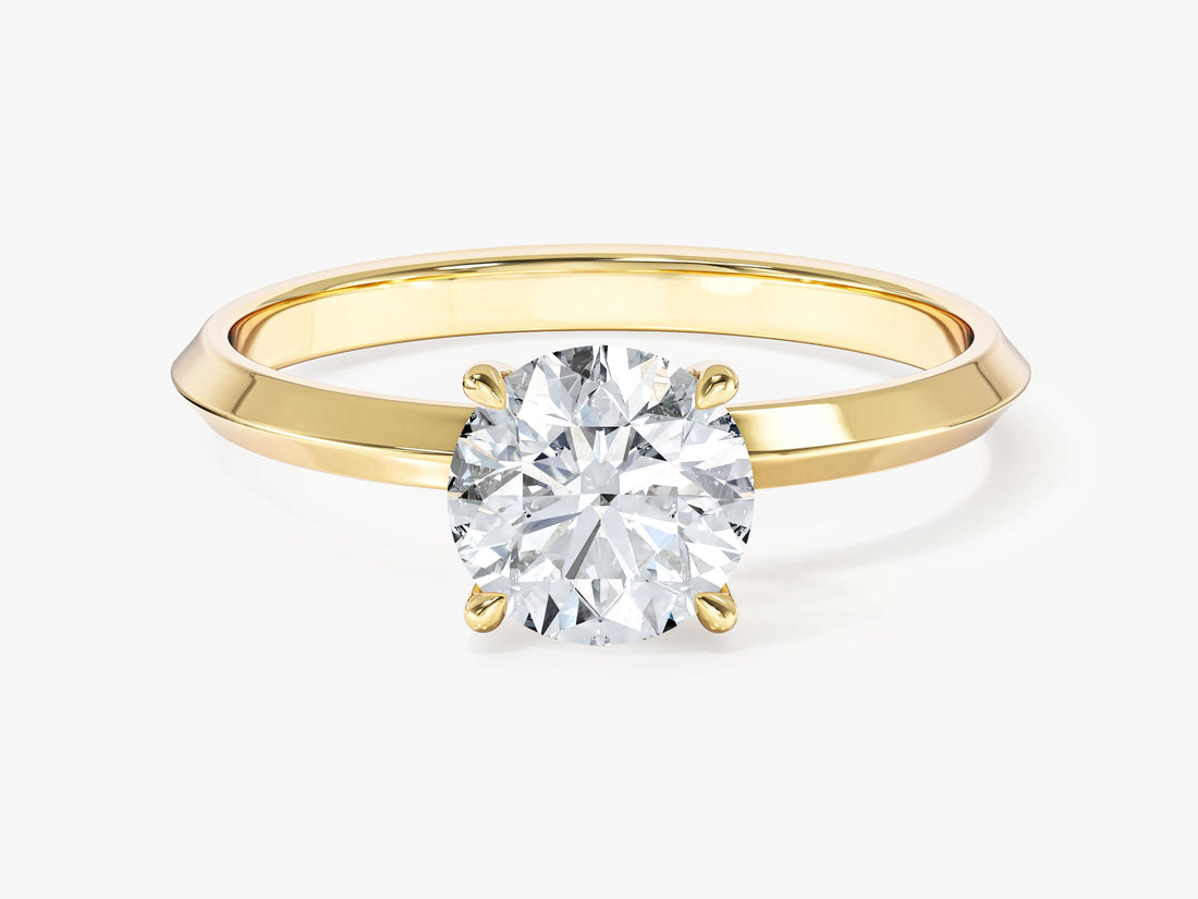 Round moissanite knife edge solitaire engagement ring in yellow gold, front view